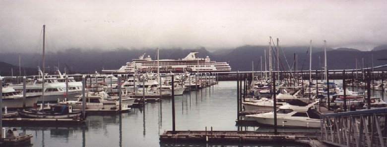 Seward small boat harbour with visiting cruise ship in the background.